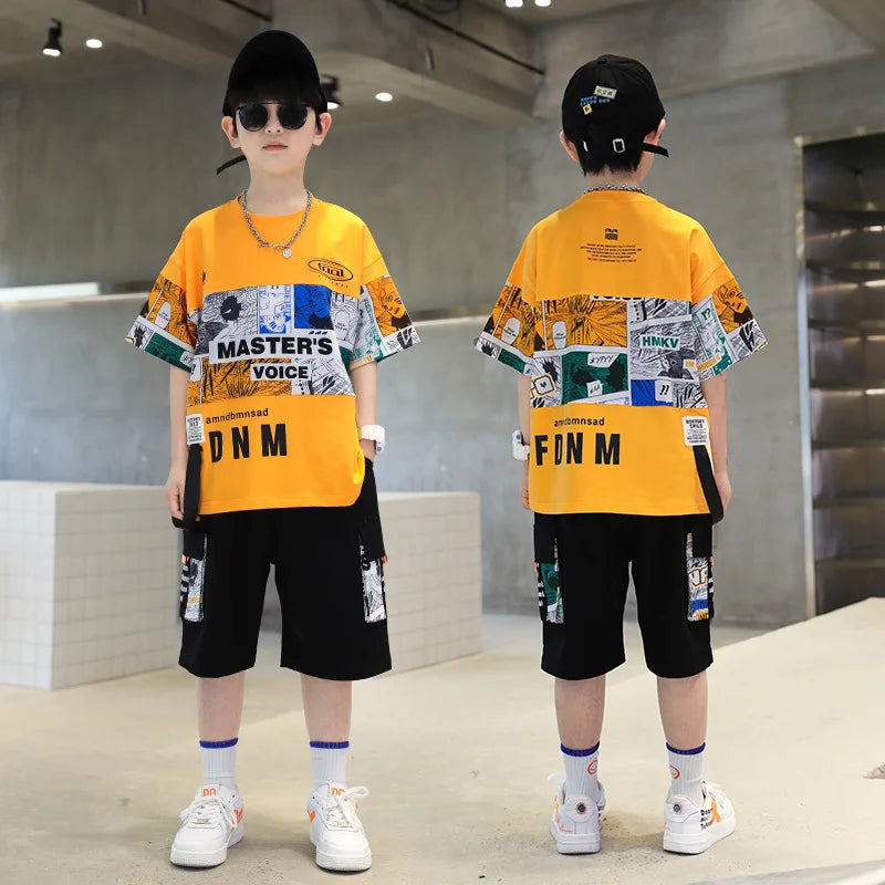 Two children wearing matching outfits with a yellow and black design in an indoor setting.