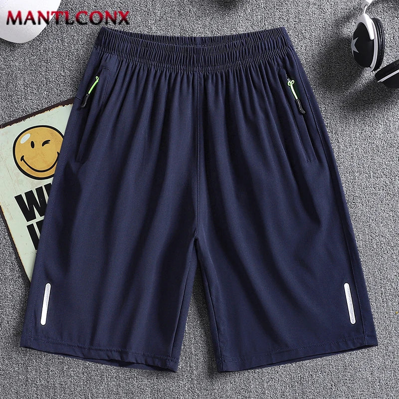Navy blue shorts with white zippers on a gray surface, featuring the brand 'MANTLCONX'.