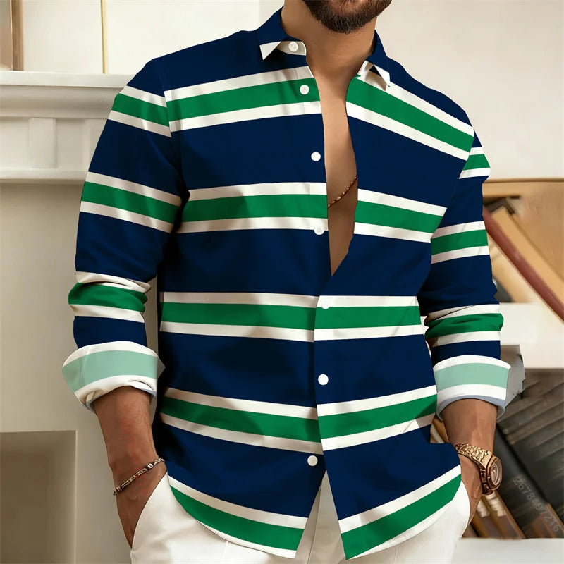 Man wearing a blue, green, and white striped shirt with a blurred background