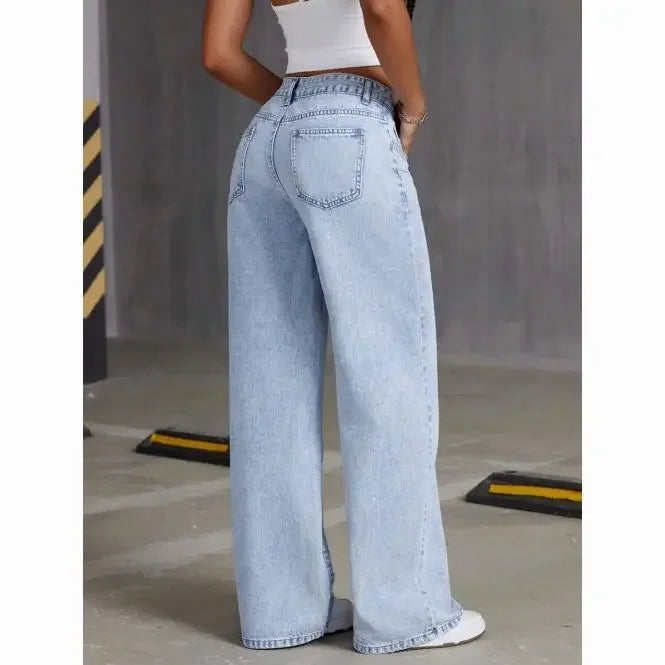Person wearing light blue jeans in an industrial setting