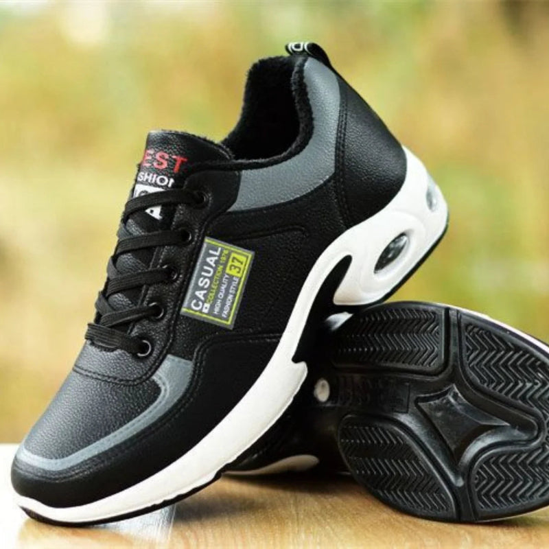 Black and gray casual shoes with a visible brand label on a wooden surface.