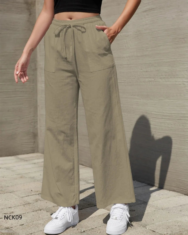 Person wearing khaki wide-leg pants with a neutral background