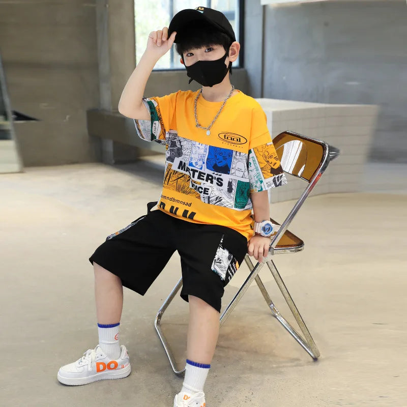 Child wearing a colorful outfit with a yellow shirt and black shorts, sitting on a chair indoors.