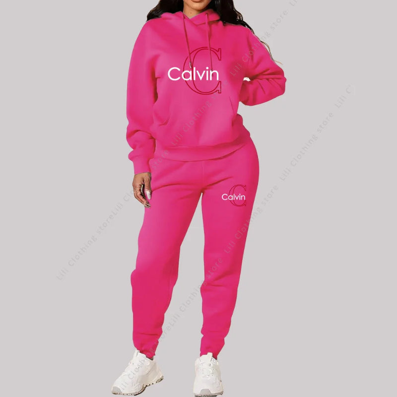 Person wearing a bright pink Calvin tracksuit on a gray background