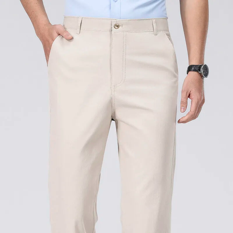 Beige pants worn by a person on a plain background