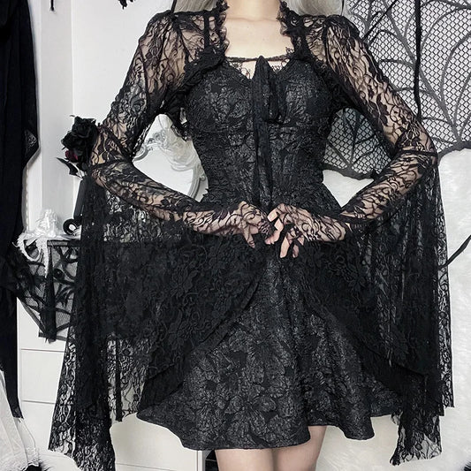 Black lace dress with long sleeves on a mannequin against a white background