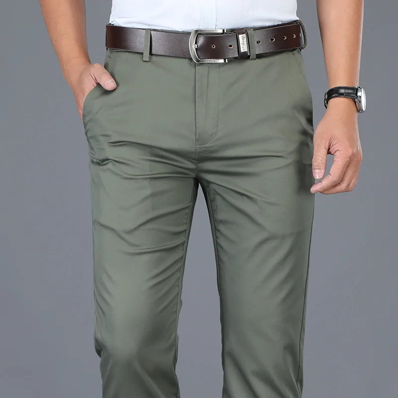 Green pants worn by a person on a gray background