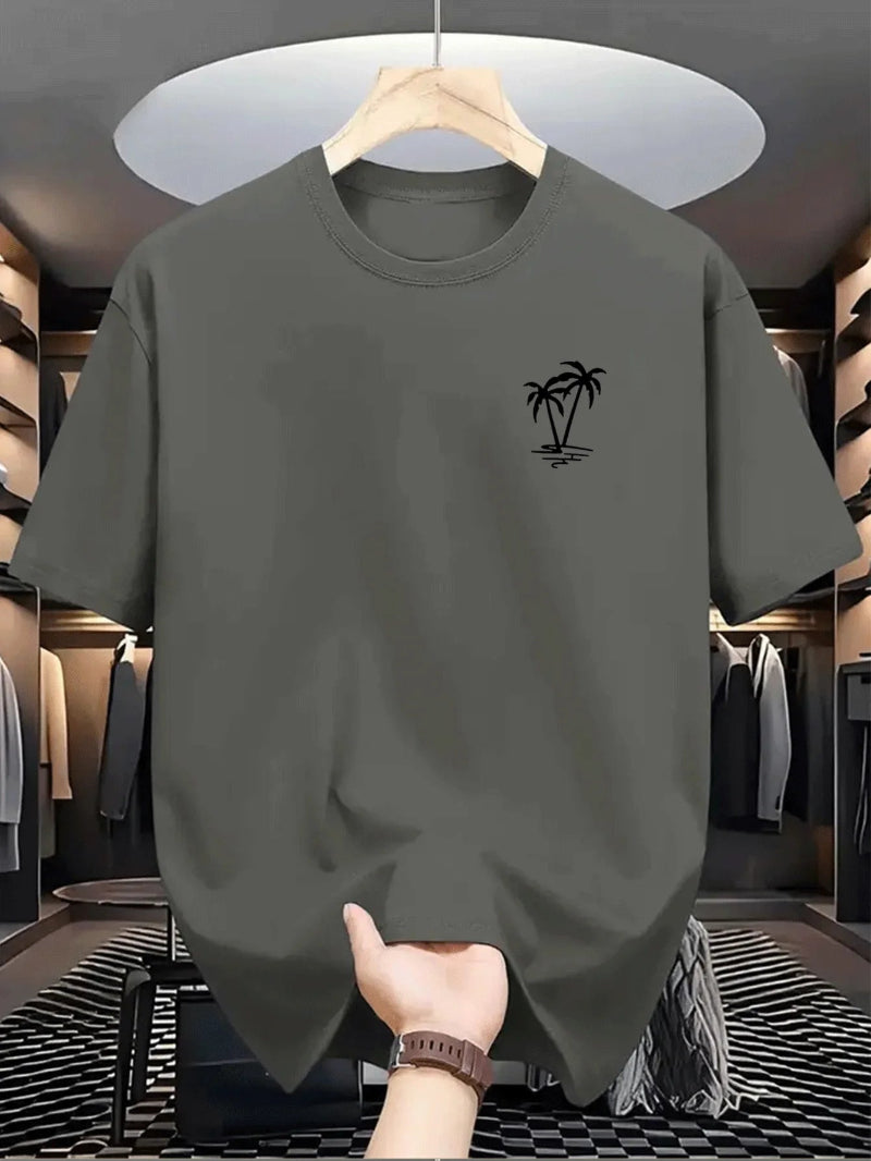 Gray t-shirt with a palm tree design on a hanger in a clothing store.